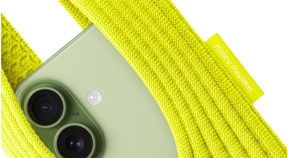 iPhone Pocket Review compact green iPhone wrapped in a yellow Issey Miyake fabric strap showcasing pocket-friendly carry design.